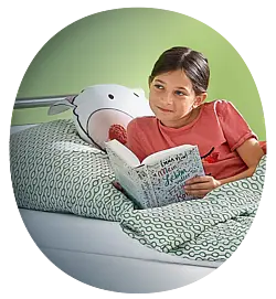 Child reading in the Seta pro - variant junior hospital bed Girl reading comfortably in the Seta pro - variant junior children’s hospital bed