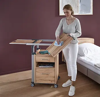 Aparto bedside cabinet for a care home room Aparto bedside cabinet by Stiegelmeyer next to a care bed in a care home room.
